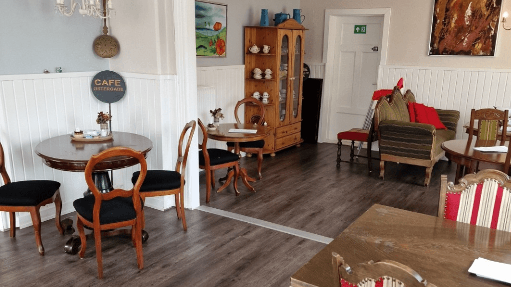 Chairs, tables, sofa, and display case at Café Østergade